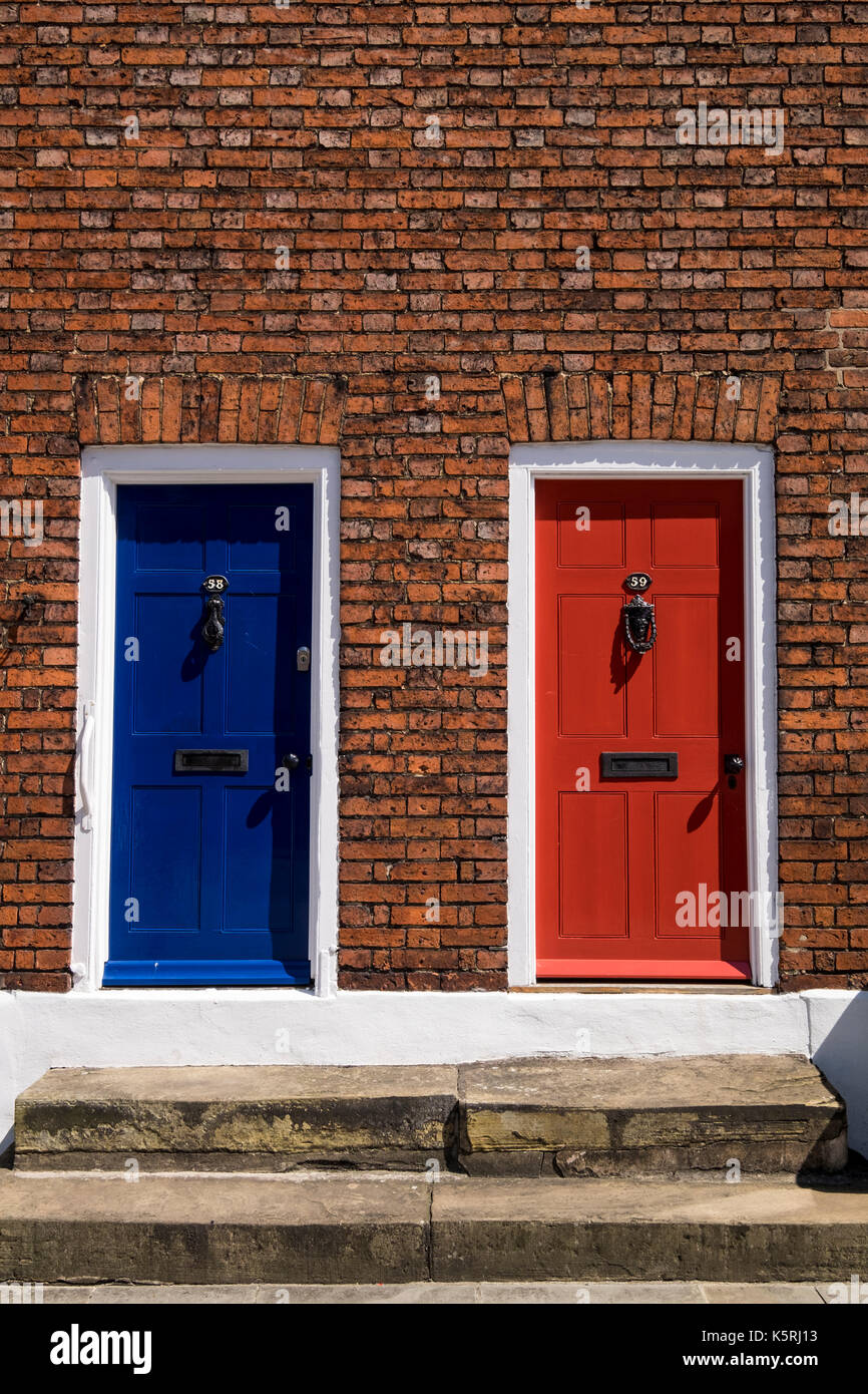 Front doors on Ermine street, City of Lincoln, colourful, red and blue, with red brick surrounding, England, UK Stock Photo