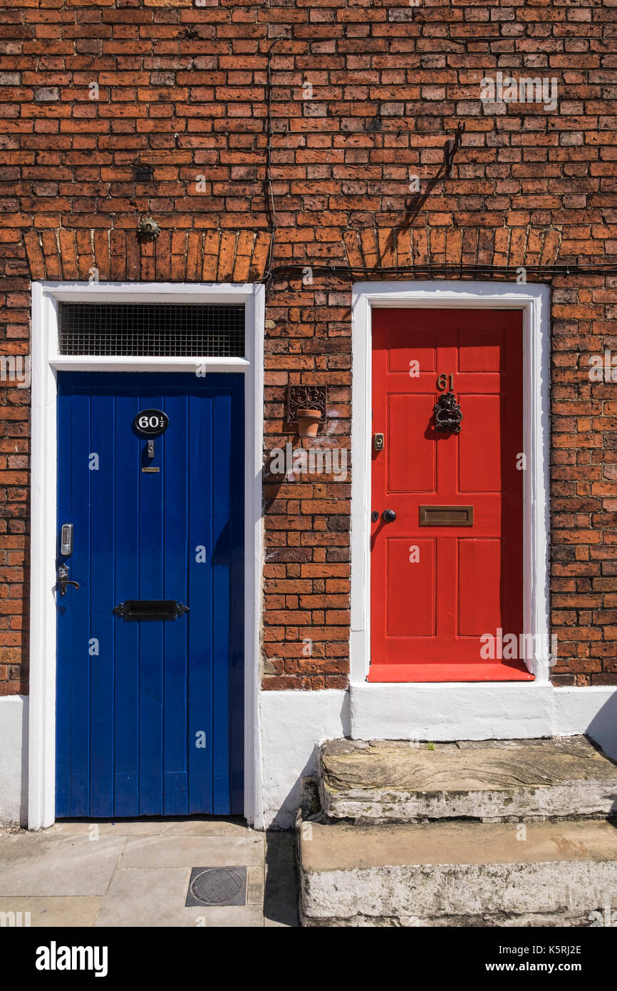 Front doors on Ermine street, City of Lincoln, colourful, red and blue, with red brick surrounding, England, UK Stock Photo
