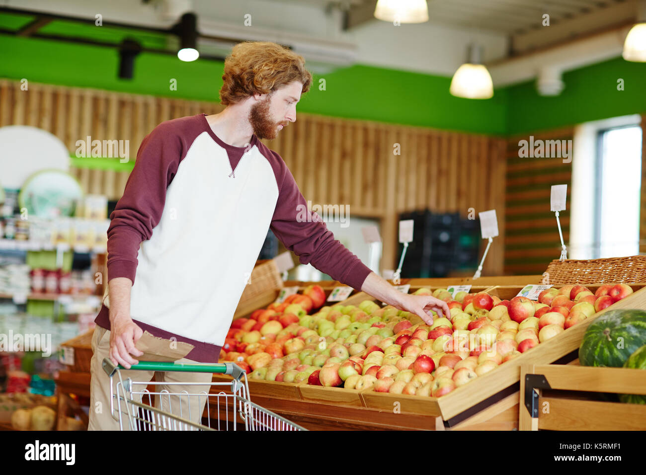 Guy choosing apples Stock Photo