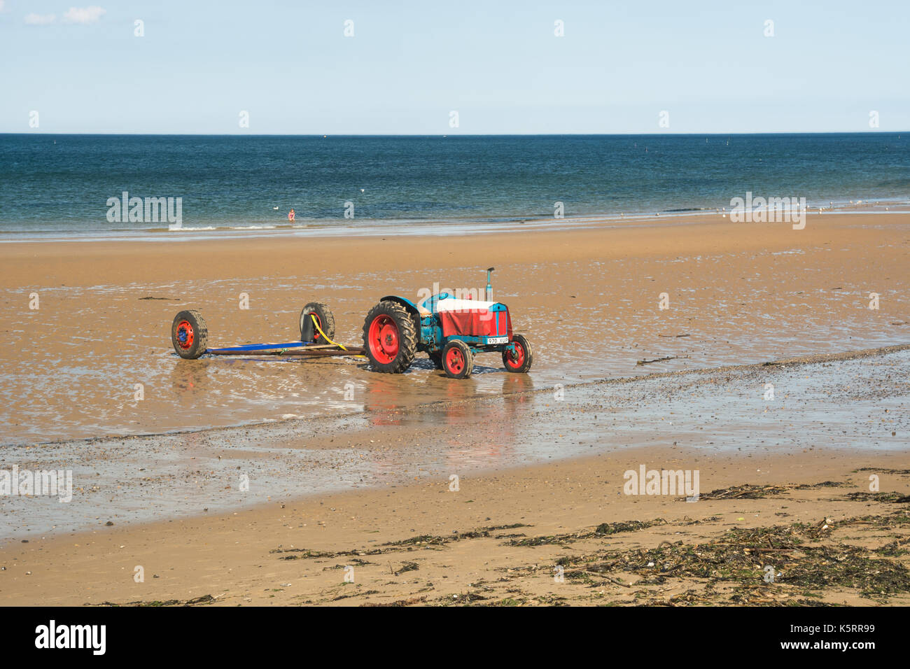 Tractor on the beach Stock Photo - Alamy