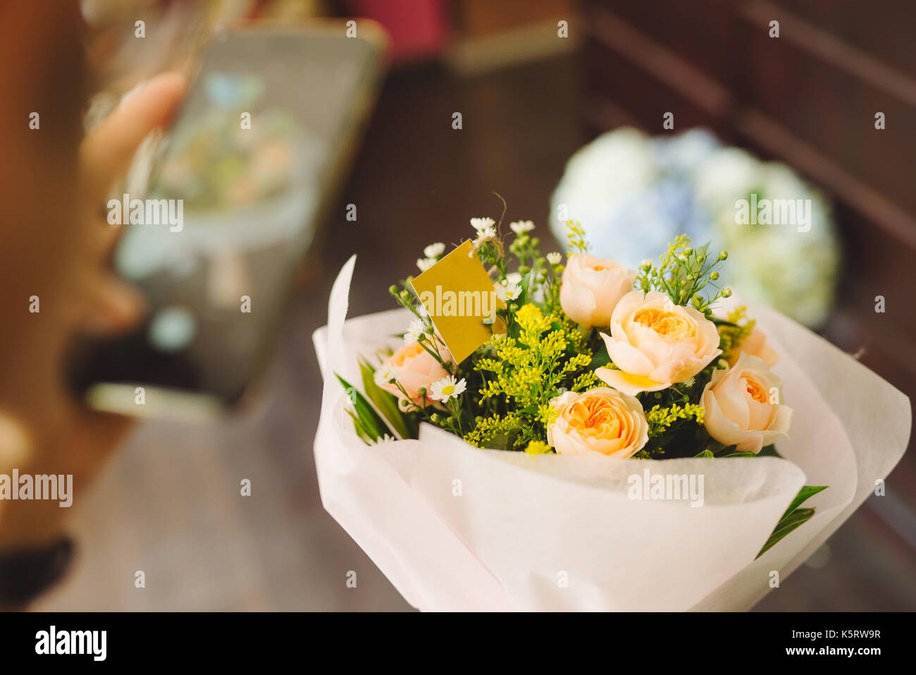 Florist guiding male customer in buying flowers at store Stock Photo