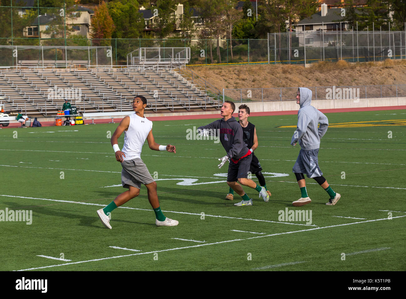 teen boys, teenage boys, boys, teenagers, playing football, pick-up football game, San Marin High School, Novato, Marin County, California Stock Photo