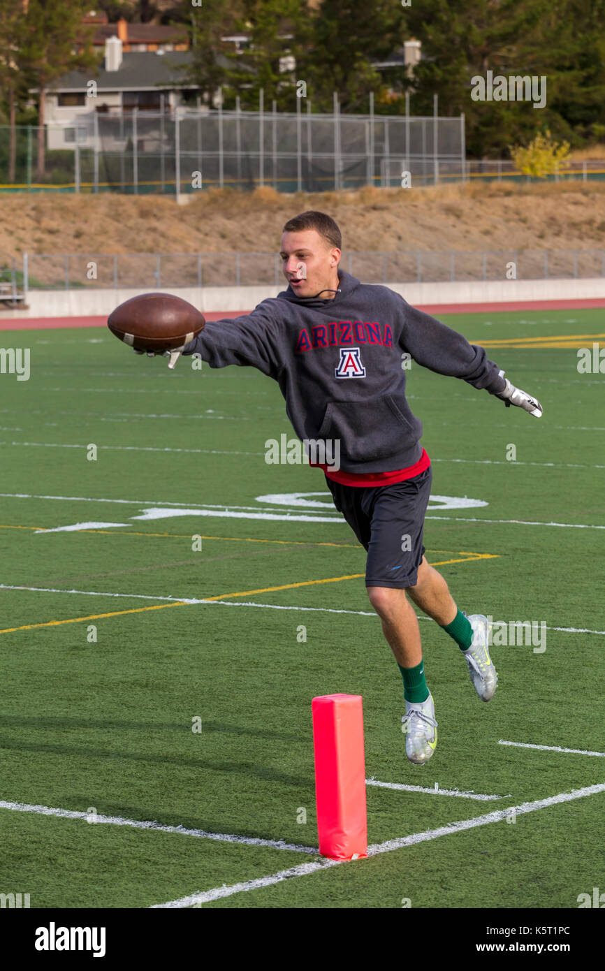 teen boy, teenage boy, boy, teenager, playing football, pick-up football game, San Marin High School, Novato, Marin County, California Stock Photo