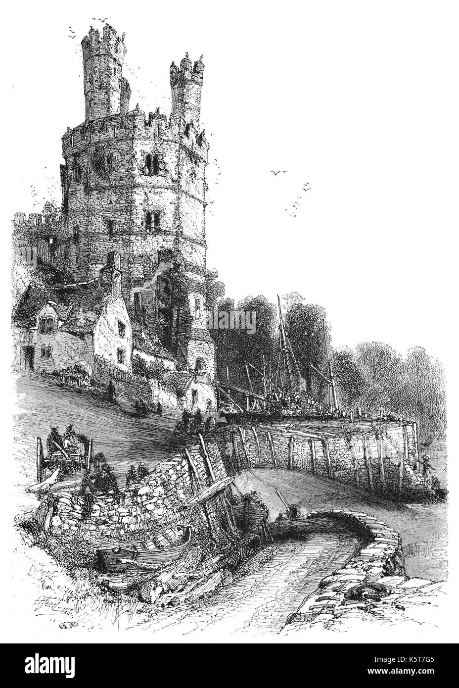 1870: A small harbour below the Eagle Tower at the western corner of medieval Caernarfon Castle, aka, Carnarvon Castle. The tower has three turrets which were once surmounted by statues of eagles and contained grand lodgings. The castle was built by King Edward I of England in 1283. Caernarfon, Gwynedd, North Wales. Stock Photo