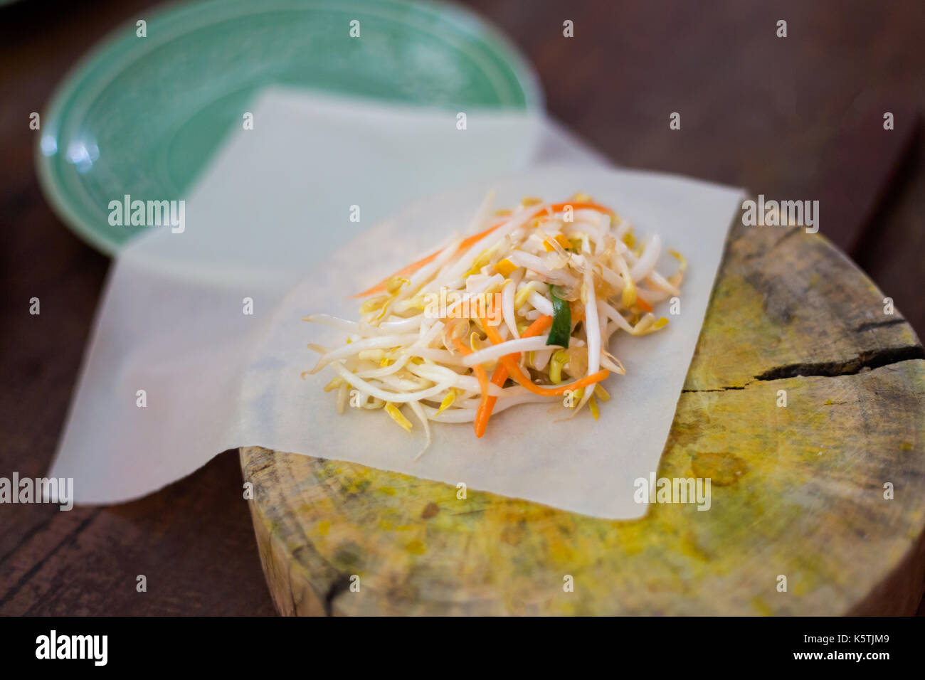 Preparing vegetarian spring rolls on chop board. Picture of traditional ...