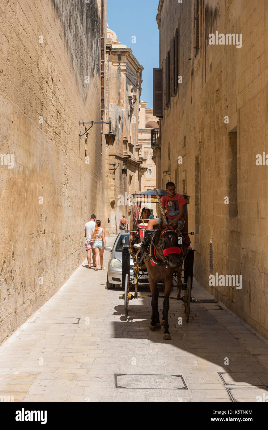 MDINA, MALTA - AUGUST 21, 2017: Tourists visiting the beautiful Silent city of Mdina.  Mdina is one of Game of Thrones movie HBO filming locations in  Stock Photo