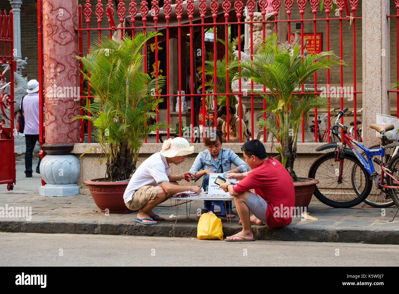 Vietnamese woman engraving grains of rice for tourists in Hoi An