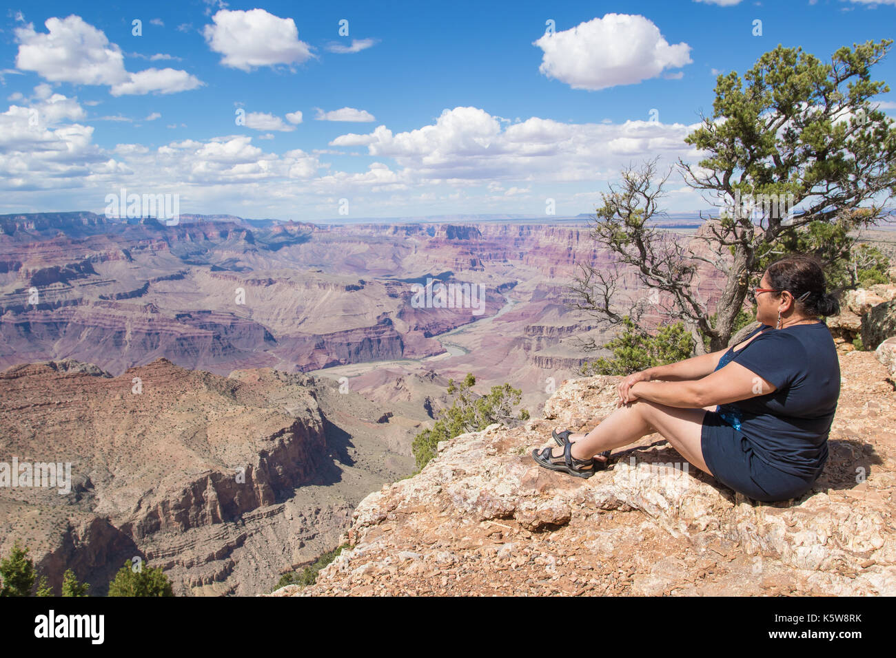 Asian woman enjoying the view on the south rim of the Grand Canyon ...