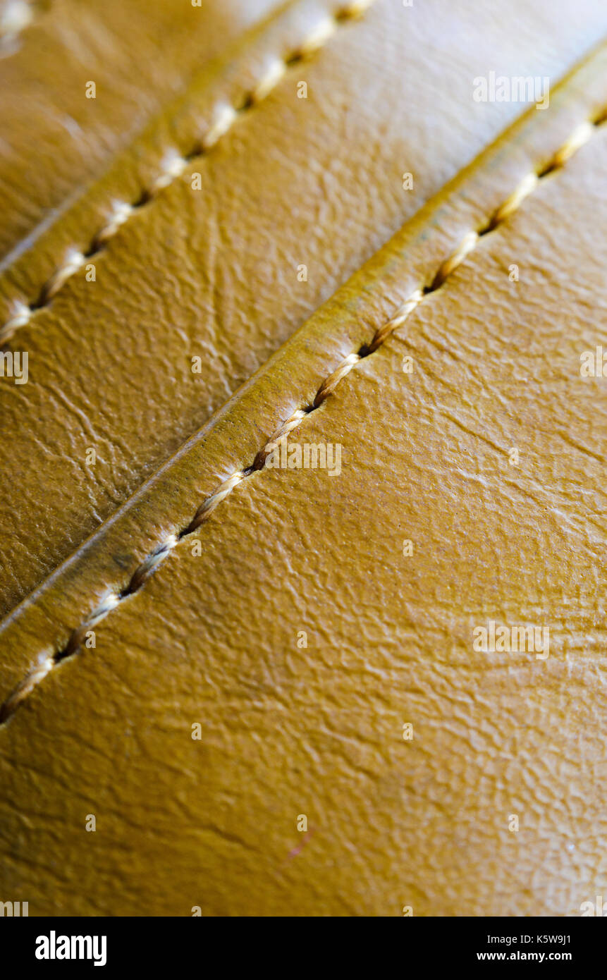 Texture of brown leather with stitches. Element of leather clothing