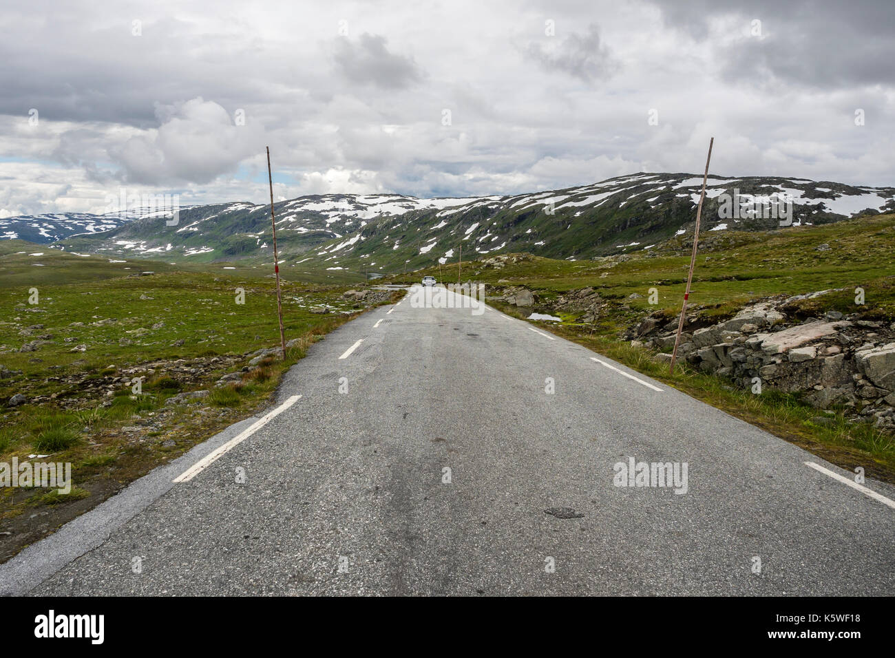 Toll road Tindevegen between  Årdal at the Sognefjord and Turtagrø, single car in lonely mountain area, western Jotunheimen, Norway Stock Photo