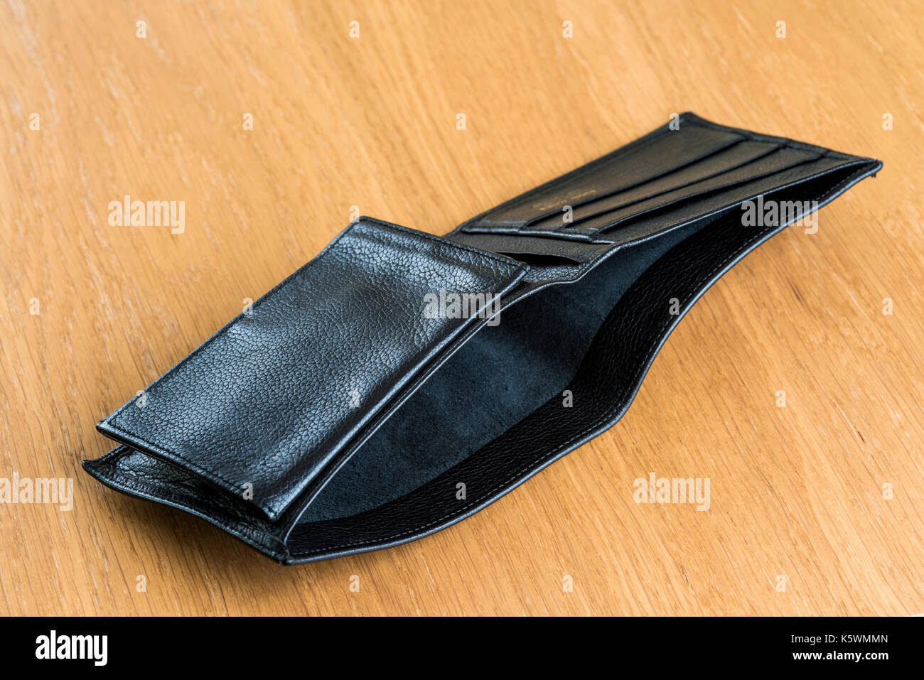 Empty leather wallet laying open on a table. Bankruptcy, unemployed, finance. Stock Photo