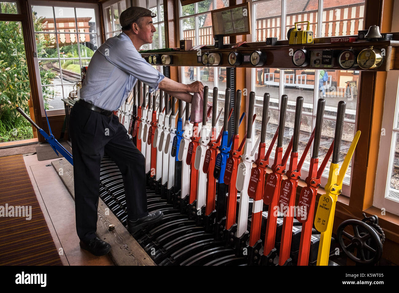 Signalman at work in the signal box at Weybourne station, North Norfolk Railway, train station, England, UK Stock Photo