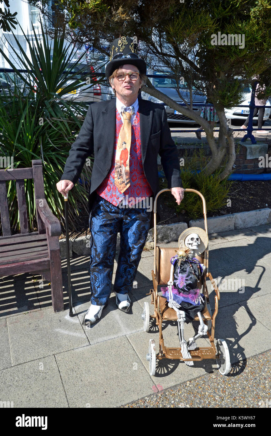 Gentleman with 'baby' skeleton in a pram at Eastbourne Steampunk Festival, Eastbourne, East Sussex, UK Stock Photo