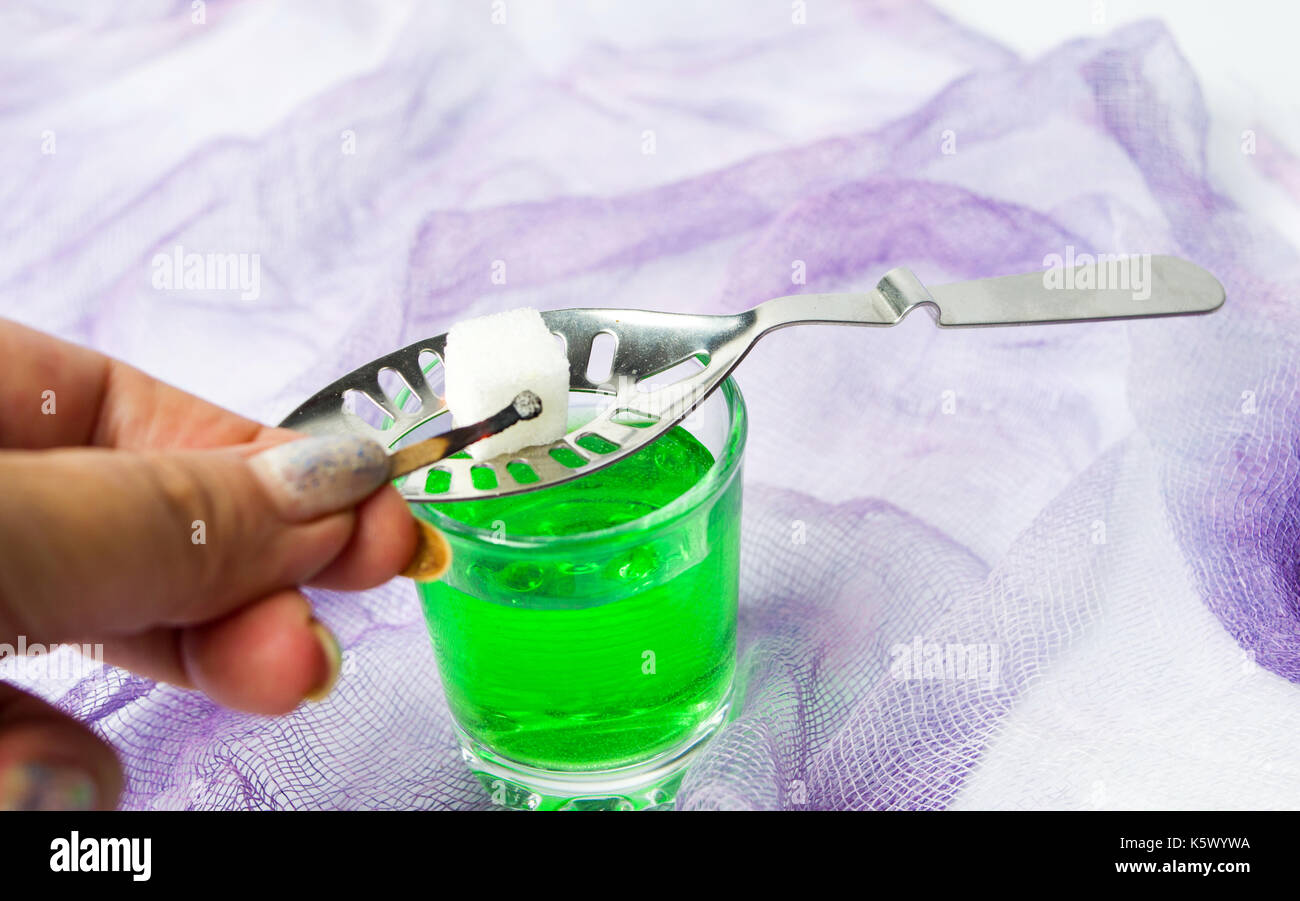 Preparing Absinthe alcohol drink with sugar and fire Stock Photo