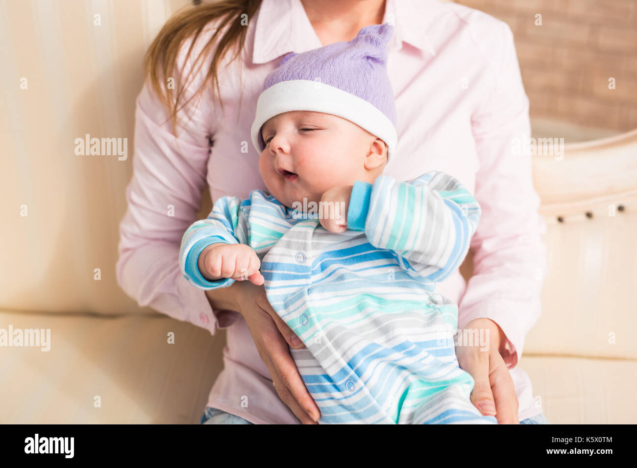 Lovely mother holding newborn baby in arms Stock Photo Alamy