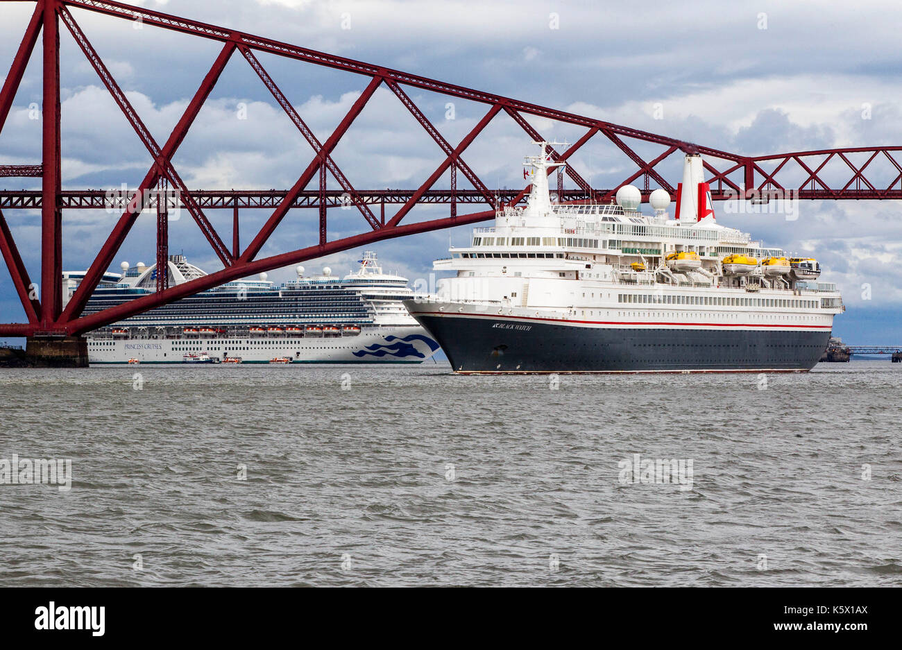 Cruise Liners in the Firth of Forth going under rail bridge Stock Photo