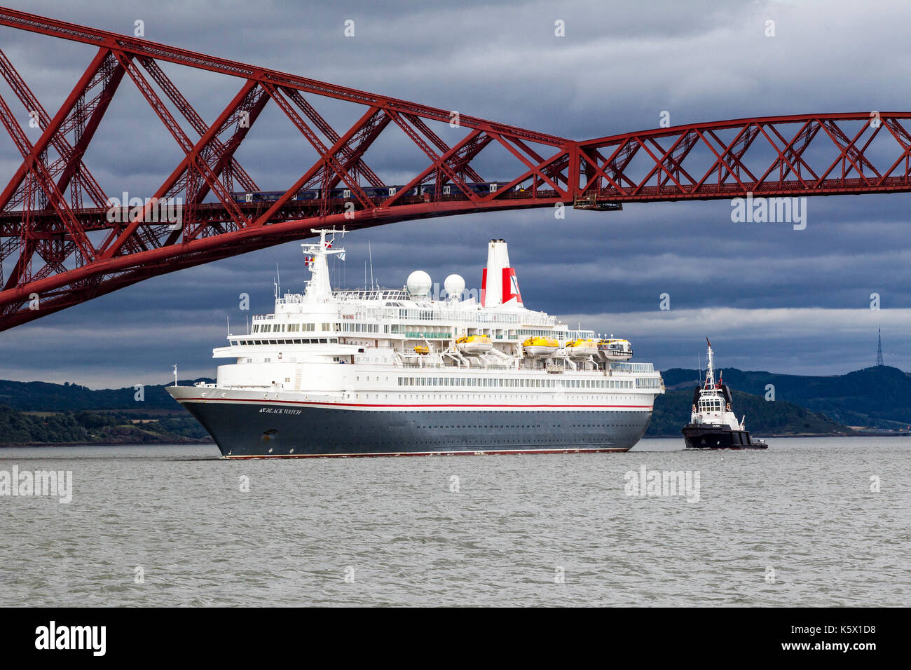 Cruise Liners in the Firth of Forth going under rail bridge Stock Photo