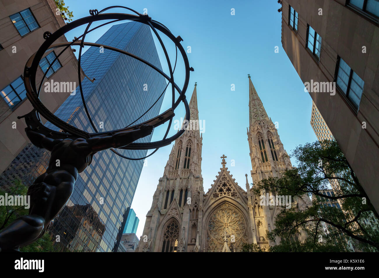 The Atlas sculpture at the Rockefeller Building with the Saint Patrick Cathedral in the background, New York City, New York. Stock Photo