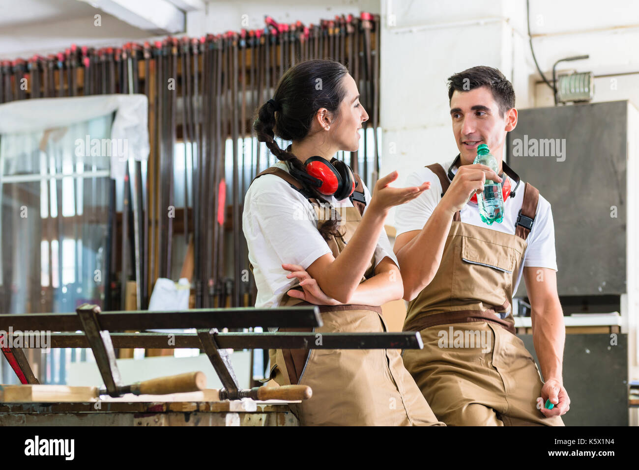 Carpenters having break from their work in wood workshop Stock Photo