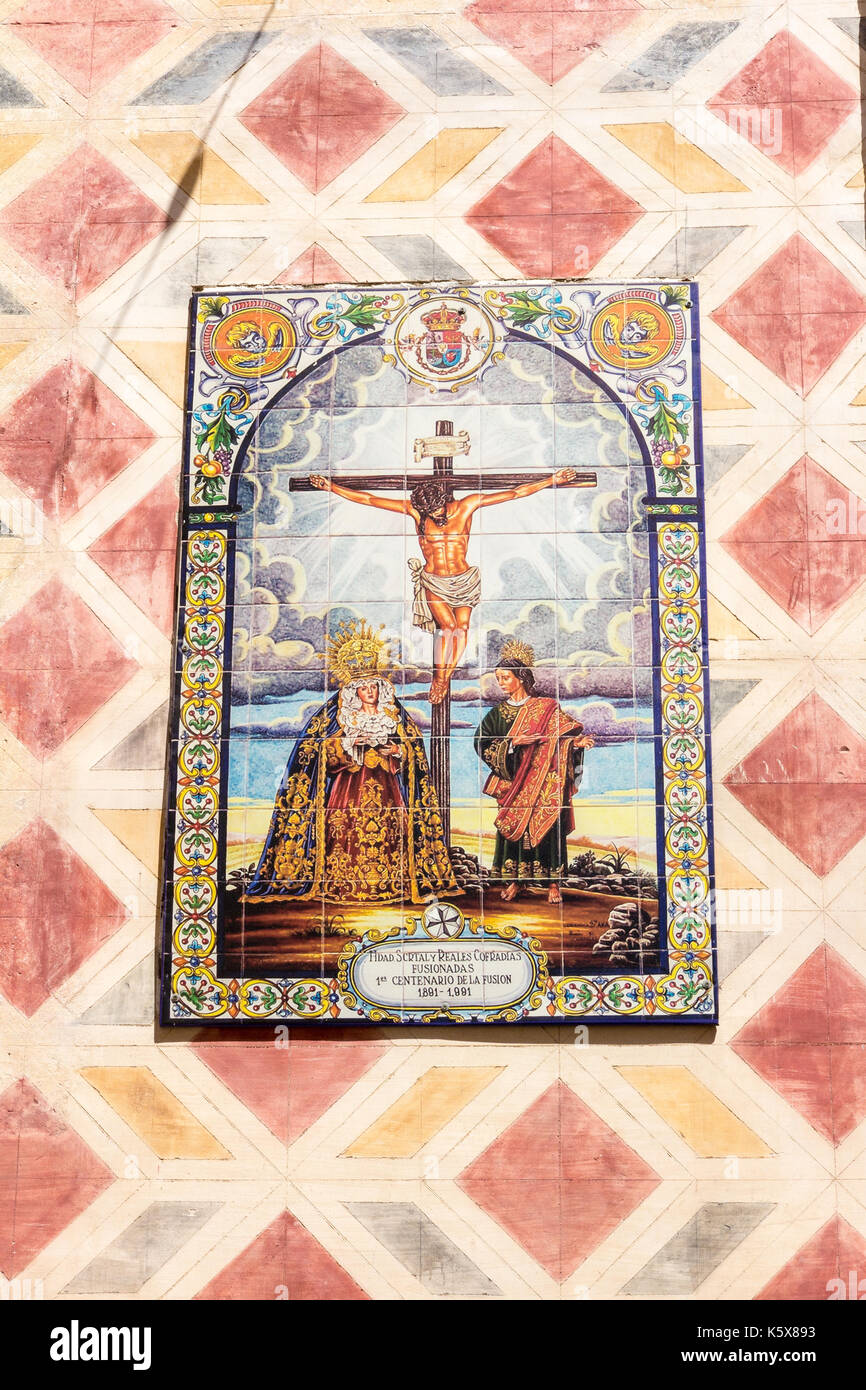 Ceramic tiling wall mural depicting Christs crucifixion on a church wall, Malaga, Spain Stock Photo