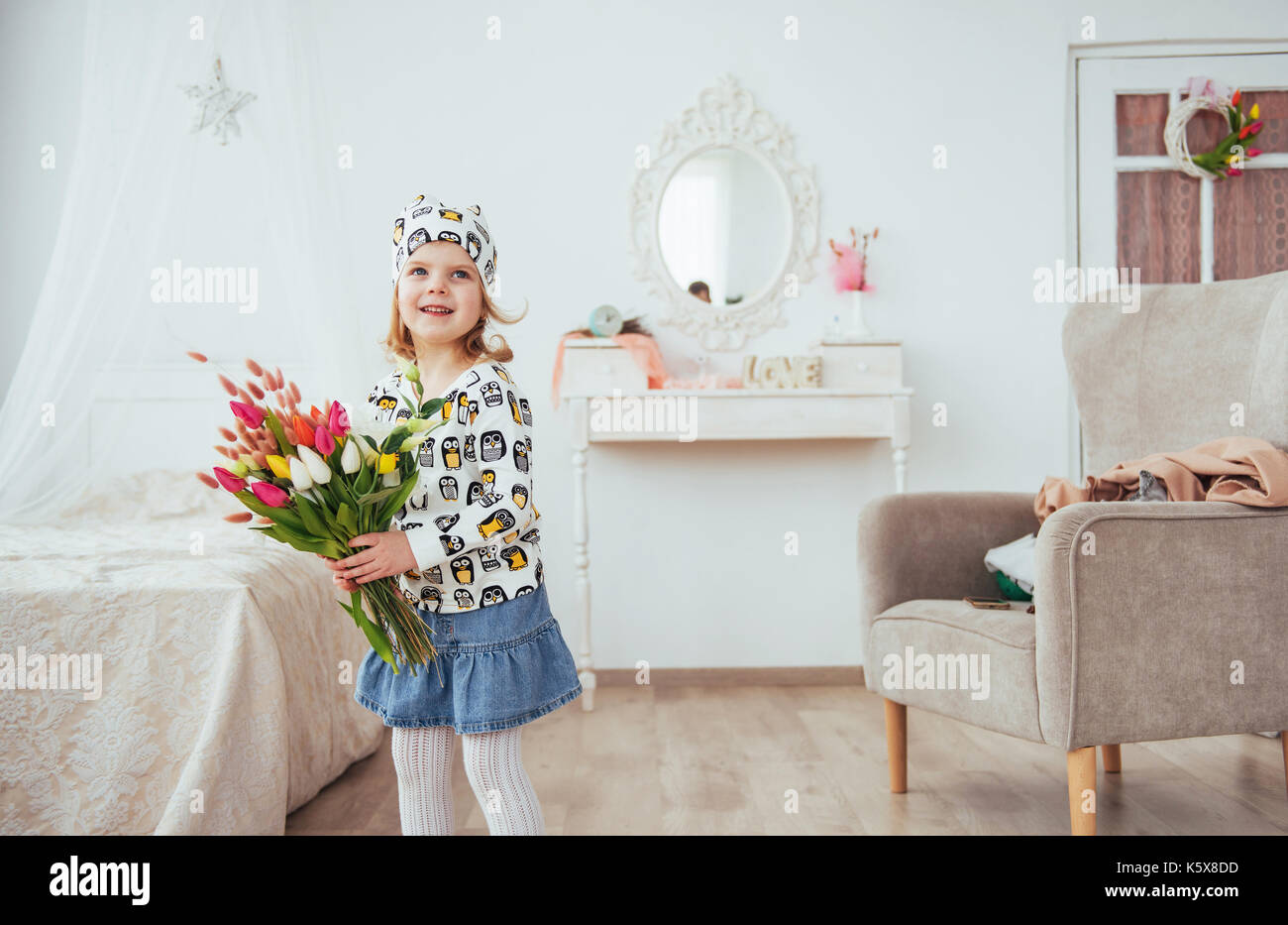 Happy girl with flowers in their hands Stock Photo - Alamy