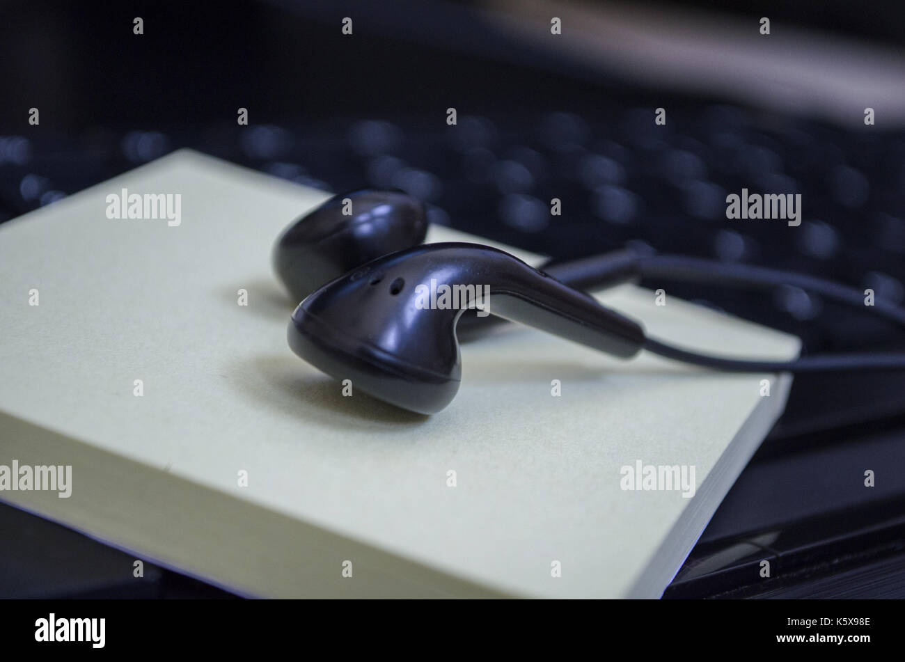 headphone over laptop keybaord Stock Photo