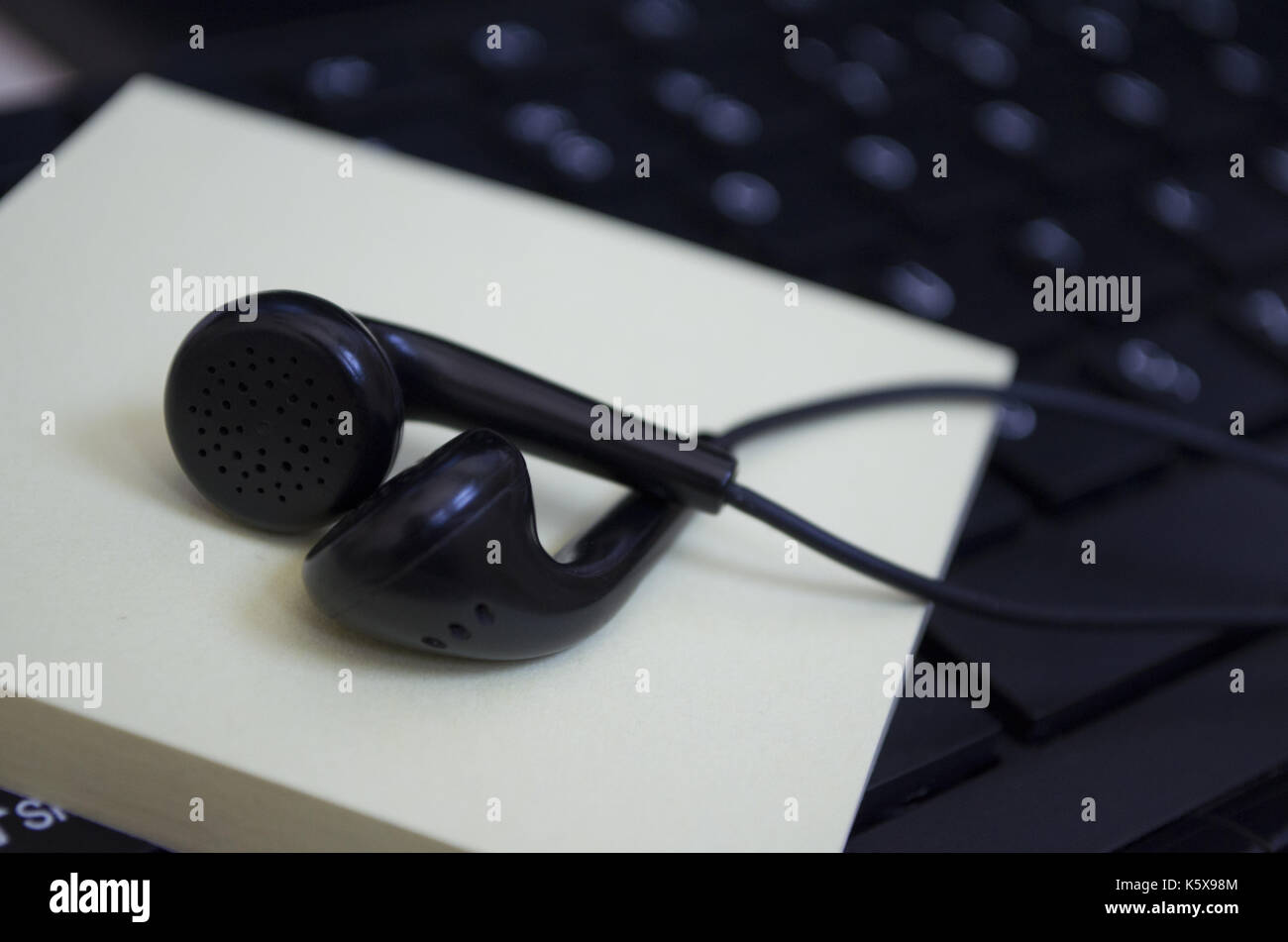 headphone over laptop keybaord Stock Photo
