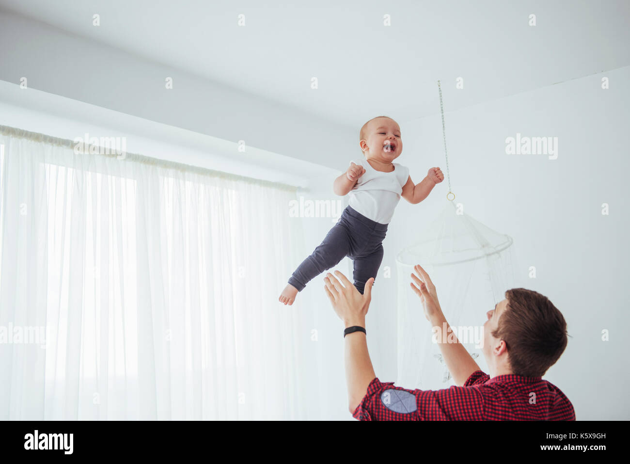 Father Tossing Baby Girl Into The Air High Resolution Stock Photography and  Images - Alamy