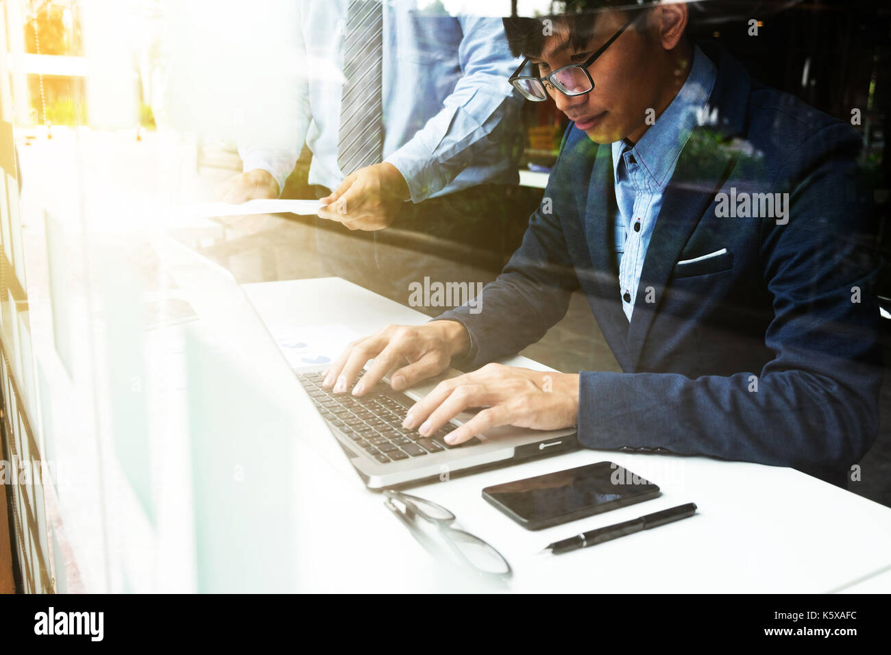 Team work process. young business managers crew working with new startup financial project. labtop on wood table, typing keyboard, texting message, an Stock Photo