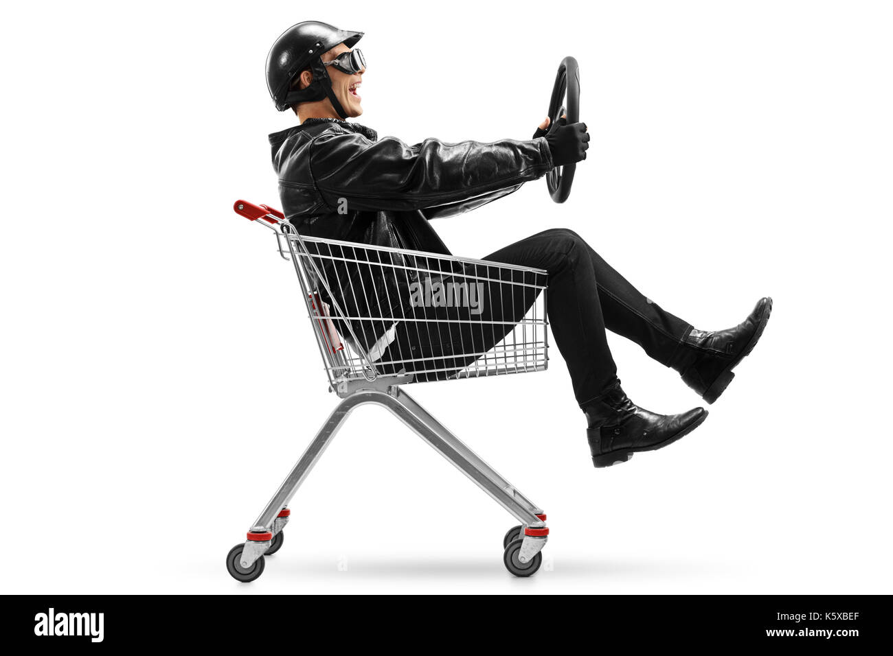 Biker riding in a shopping cart and holding a steering wheel isolated on white background Stock Photo