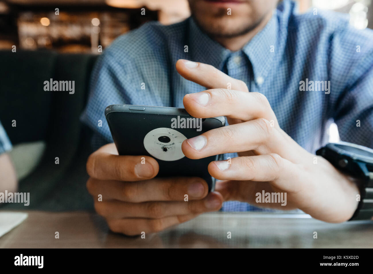 Hands of a man using a smartphone. Stock Photo