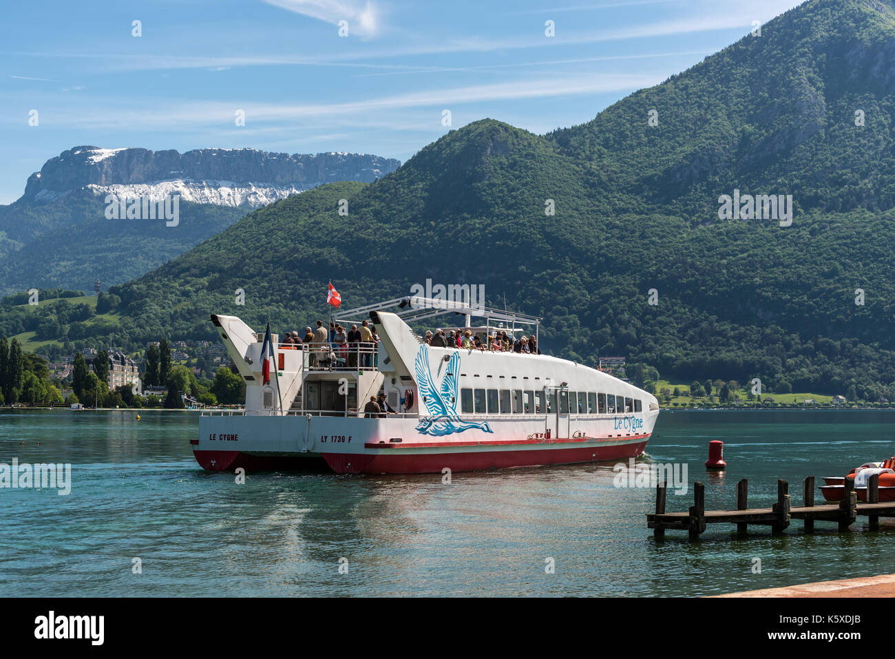Annecy, France - May 25, 2016: Le Cygne catamaran trip boat on Annecy lake, Haute-Savoie, France. Stock Photo