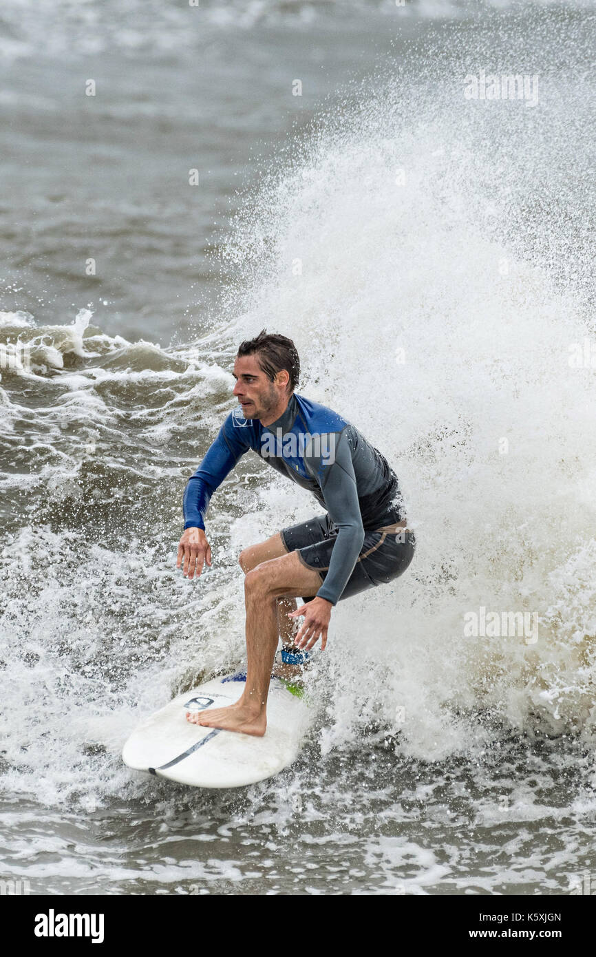 Folly Beach, United States. 10th Sep, 2017. A surfer enjoys the extreme waves caused by a tidal serge from Hurricane Irma at the Folly Washout September 10, 2017 in Folly Beach, South Carolina. Imra is expected to spare the Charleston area but hurricane will bring a tidal serge and will cause flooding along the coast. Credit: Planetpix/Alamy Live News Stock Photo
