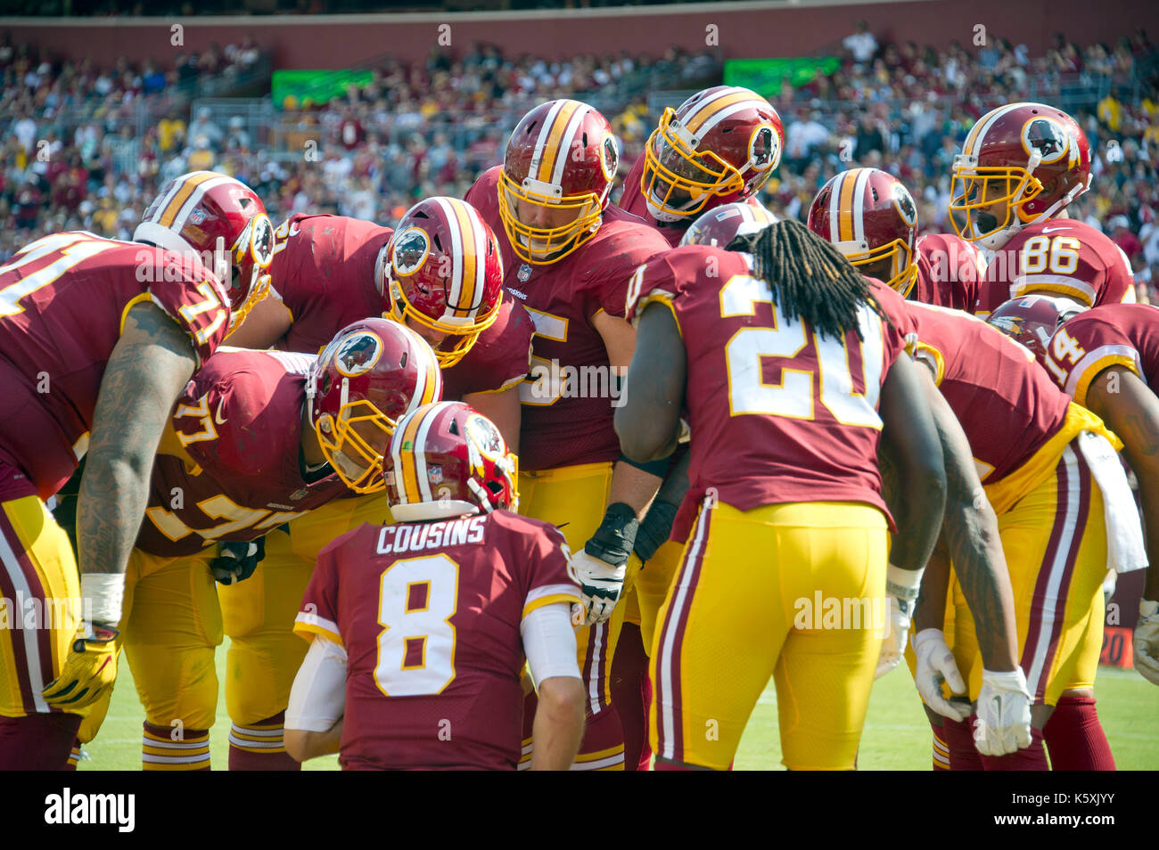 Philadelphia Eagles quarterback Carson Wentz (11) looks at the scoreboard  replay of a fumble his team returned for a touchdown in the fourth quarter  against the Washington Redskins at FedEx Field in