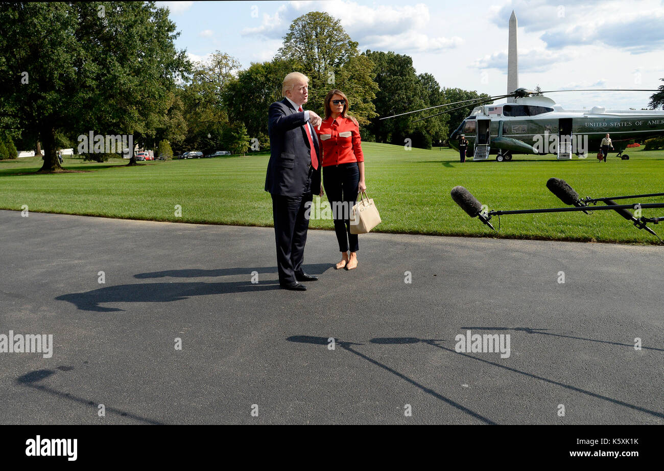 United States President Donald J. Trump speaks to members of the media about Hurricane Irma as first lady Melania Trump looks on upon their arrival on the South Lawn of the White House in Washington, DC, September 10, 2017, after spending the weekend at Camp David, the Presidential retreat near Thurmont, Maryland. Credit: Olivier Douliery/Pool via CNP /MediaPunch Stock Photo