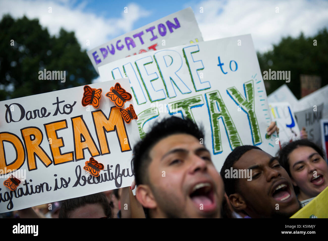 Placards and protesters seen during the DACA protest. A small crowd gathers in front of the White House to protest President Donald Trump's intention to rescind the Deferred Action for Childhood Arrivals Act, also known as DACA or the Dream Act. Deferred Action for Childhood Arrivals (DACA) is a kind of administrative relief from deportation. The purpose of DACA is to protect eligible immigrant youth who came to the United States when they were children from deportation. DACA gives young undocumented immigrants: 1) protection from deportation, and 2) a work permit. The program expires after tw Stock Photo