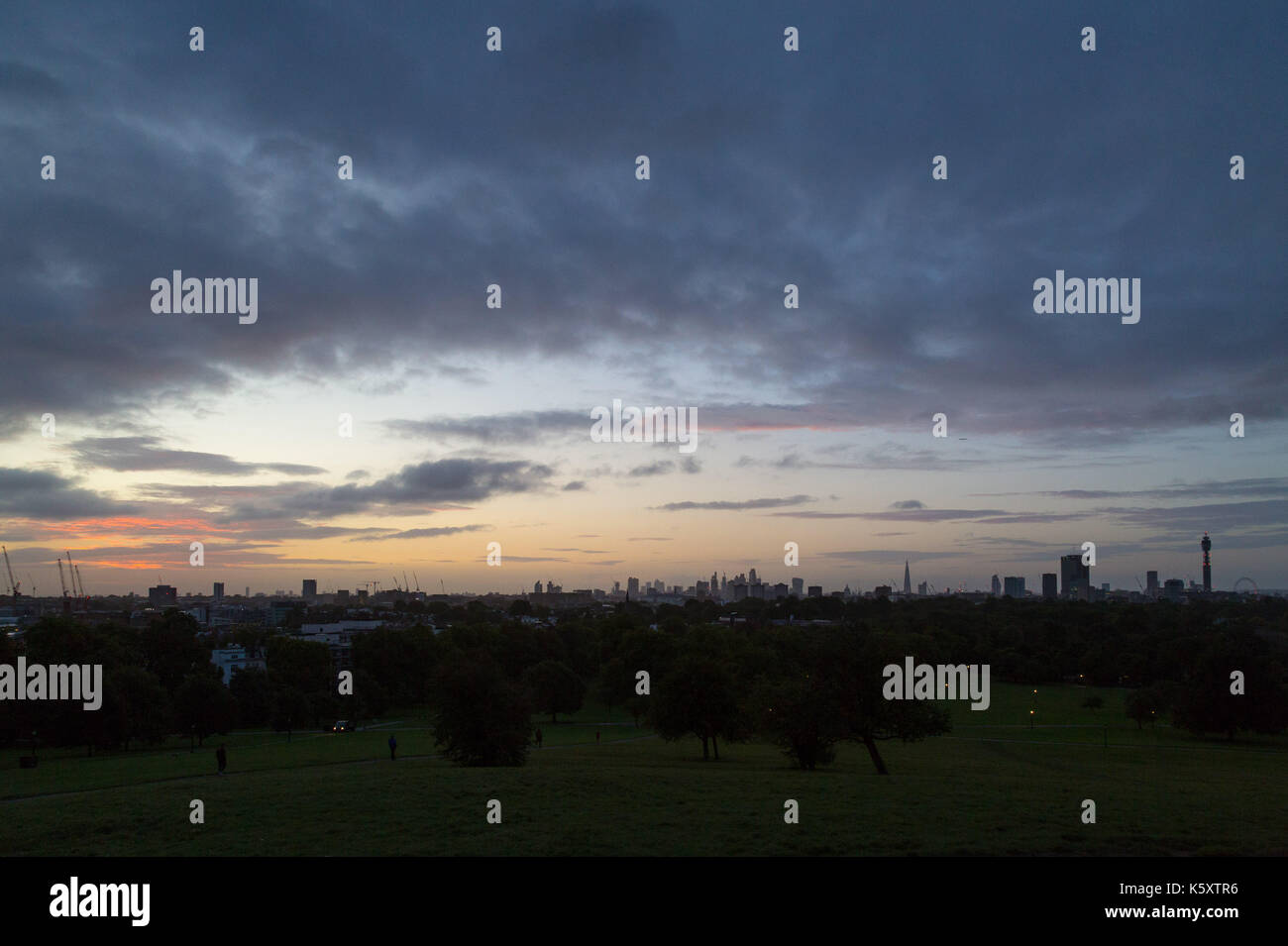 London, UK. 11th Sep, 2017. London, September 11 2017. The rising sun illuminates the clouds above the London skyline as a new day breaks over the city. Credit: Paul Davey/Alamy Live News Stock Photo