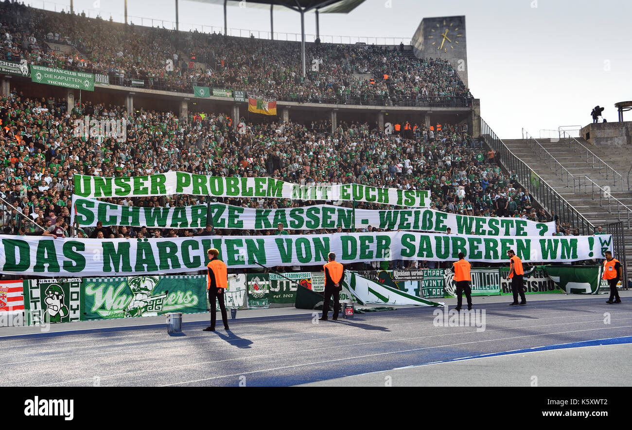Berlin, Germany. 10th Sep, 2017. Fans of Bremen hold up banners reading: 'Unser Problem mit Euch: Schwarze Kassen, Weiße Weste. Das Märchen von der sauberen WM' (lit. 'Our problem with you: Black checkout, white vests. The fairytale of the clean World Cup') during the German Bundesliga soccer match between Hertha BSC and Werder Bremen at the Olympia stadium in Berlin, Germany, 10 September 2017. Photo: Soeren Stache/dpa/Alamy Live News Stock Photo