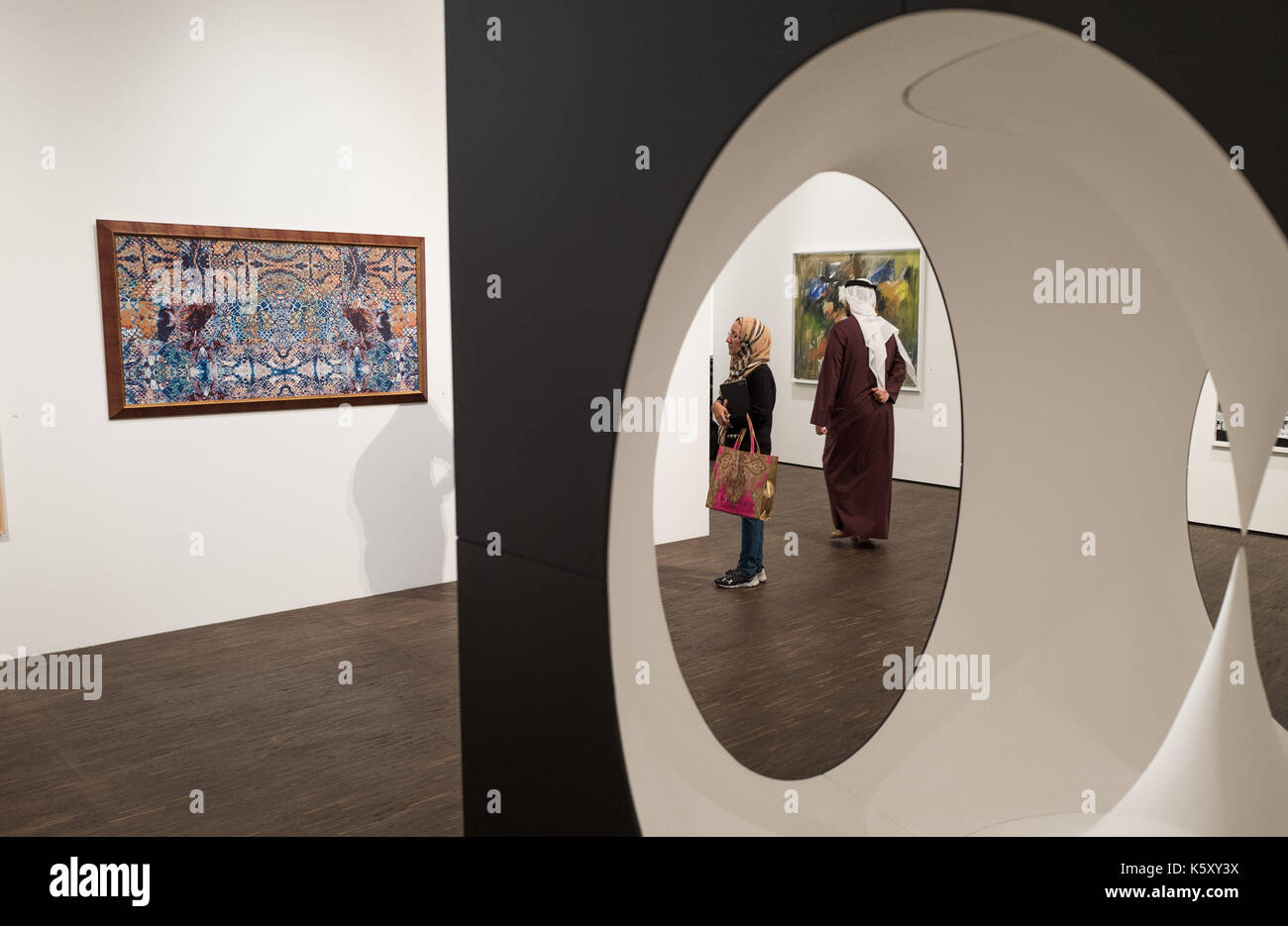 Berlin, Germany. 11th Sep, 2017. A visitor can be seen looking at the work 'Arabian Oryx' of the artist Saeed Al Madani through the installation 'Inner Pilgrimage' of the artist Aisha Juma at the exhibition 'Portrait of a Nation' at the 'me Collectors Room' in Berlin, Germany, 11 September 2017. The exhibition is taking place as part of the Berlin Art Week, which will be held from the 13th to the 17th of September 2017. (ATTENTION EDITORS: EDITORIAL USE ONLY IN CONNECTION WITH CURRENT REPORTING/MANDATORY CREDIT: 'Jörg Carstensen/dpa') Photo: Jörg Carstensen/dpa/Alamy Live News Stock Photo