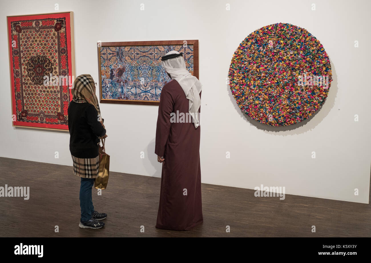 Berlin, Germany. 11th Sep, 2017. Visitors can be seen at the exhibition 'Portrait of a Nation' at the 'me Collectors Room' in Berlin, Germany, 11 September 2017. The exhibition is taking place as part of the Berlin Art Week, which will be held from the 13th to the 17th of September 2017. (ATTENTION EDITORS: EDITORIAL USE ONLY IN CONNECTION WITH CURRENT REPORTING/MANDATORY CREDIT: 'Jörg Carstensen/dpa') Photo: Jörg Carstensen/dpa/Alamy Live News Stock Photo