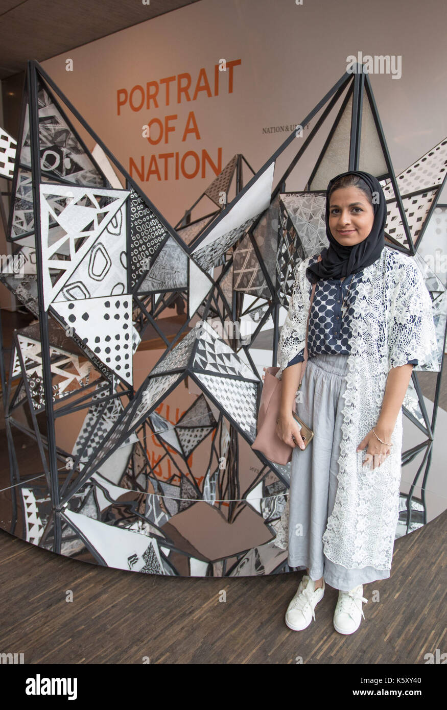 Berlin, Germany. 11th Sep, 2017. The artist Eman Alhashemi stands next toher installation 'Around' at the exhibition 'Portrait of a Nation' at the 'me Collectors Room' in Berlin, Germany, 11 September 2017. The exhibition is taking place as part of the Berlin Art Week, which will be held from the 13th to the 17th of September 2017. (ATTENTION EDITORS: EDITORIAL USE ONLY IN CONNECTION WITH CURRENT REPORTING/MANDATORY CREDIT: 'Jörg Carstensen/dpa') Photo: Jörg Carstensen/dpa/Alamy Live News Stock Photo