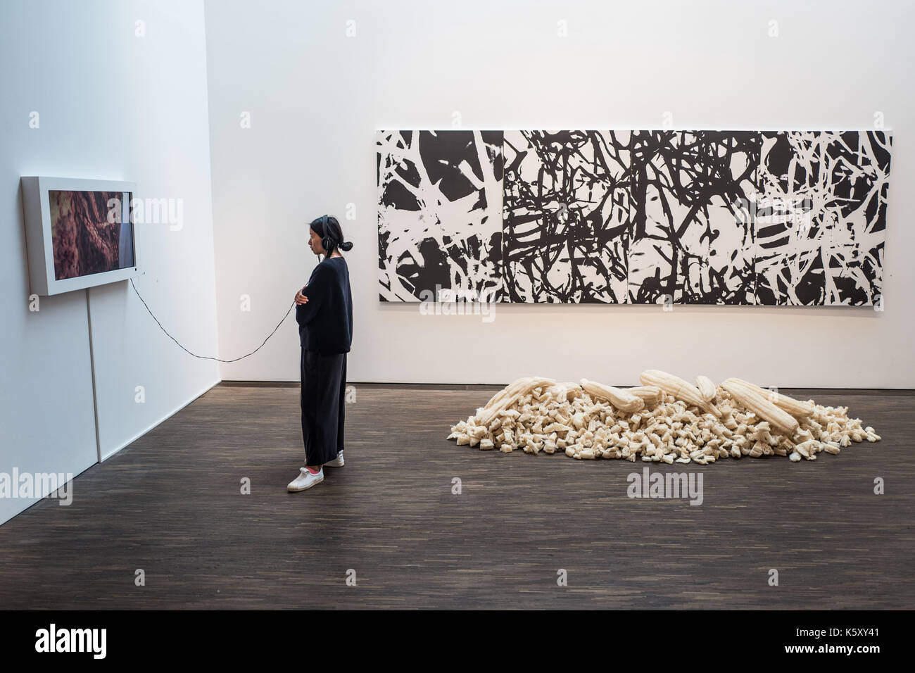 Berlin, Germany. 11th Sep, 2017. A visitor stands next to an installation of the artist Mohammed Al Qassab at the exhibition 'Portrait of a Nation' at the 'me Collectors Room' in Berlin, Germany, 11 September 2017. The exhibition is taking place as part of the Berlin Art Week, which will be held from the 13th to the 17th of September 2017. (ATTENTION EDITORS: EDITORIAL USE ONLY IN CONNECTION WITH CURRENT REPORTING/MANDATORY CREDIT: 'Jörg Carstensen/dpa') Photo: Jörg Carstensen/dpa/Alamy Live News Stock Photo