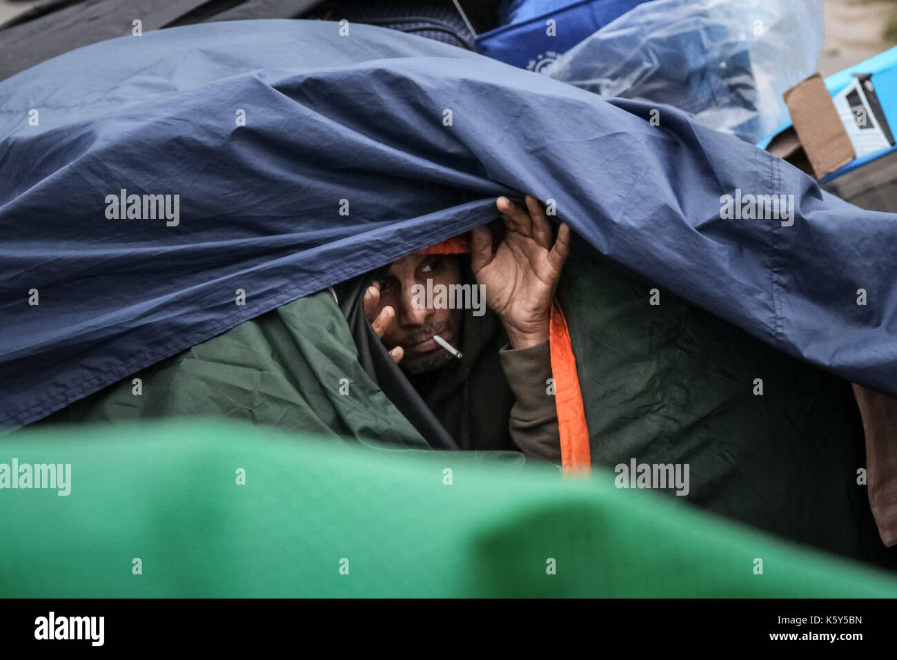 A protester peers from inside their tent on Parliament Square, part of the ‘Democracy Village’ peace campaign which saw multiple activists pitching tents on the pavement area around Parliament Square in Westminster, London, UK. Stock Photo