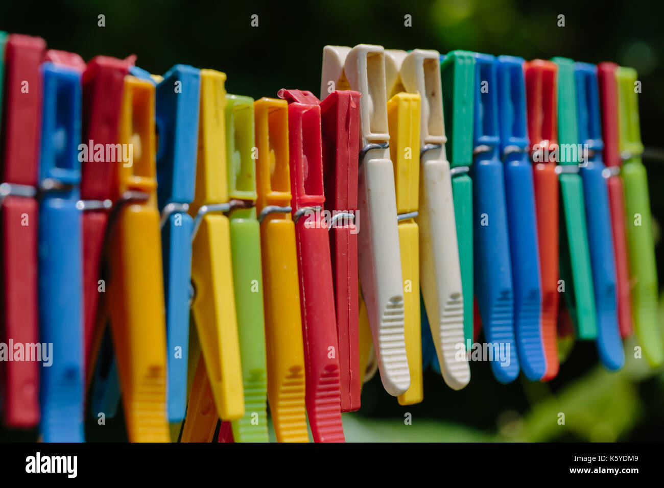 Colorful group of clothespins on a rope Stock Photo Alamy