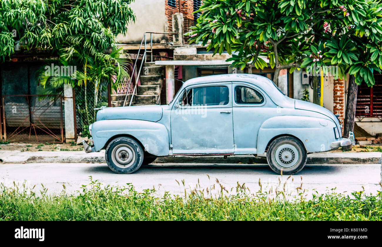 Antique car parked on road in Cuba. Stock Photo