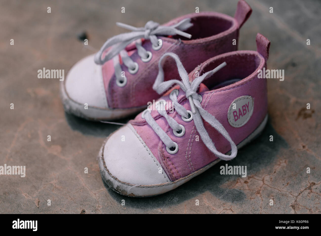Old baby sneakers closeup photo. Stock Photo