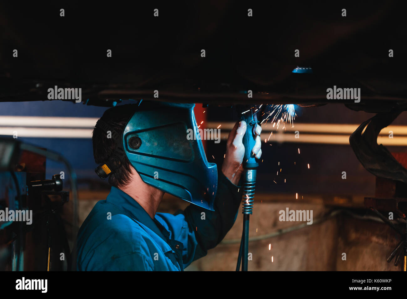 Man in a mask does welding machines. Stock Photo