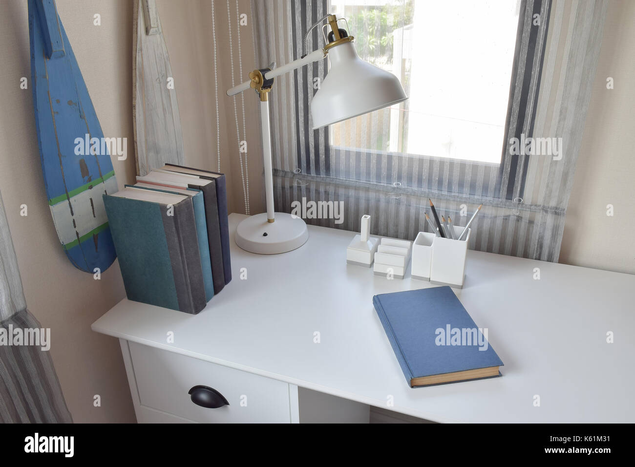 work table with lamp,pencils and books in working room Stock Photo - Alamy