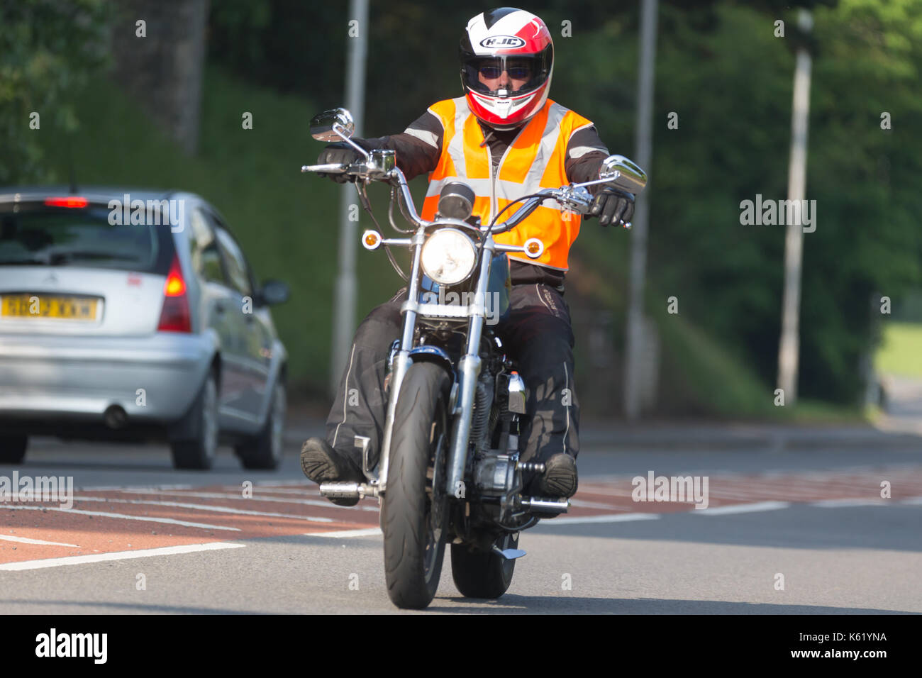 motorcyclists riding his motorbike along the road Stock Photo