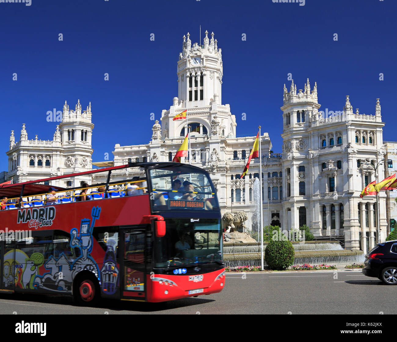 MADRID, SPAIN - JUNE 26, 2017: Madrid City Tour Bus passing in front of Cybele Palace with tourist enjoying the ride. Stock Photo